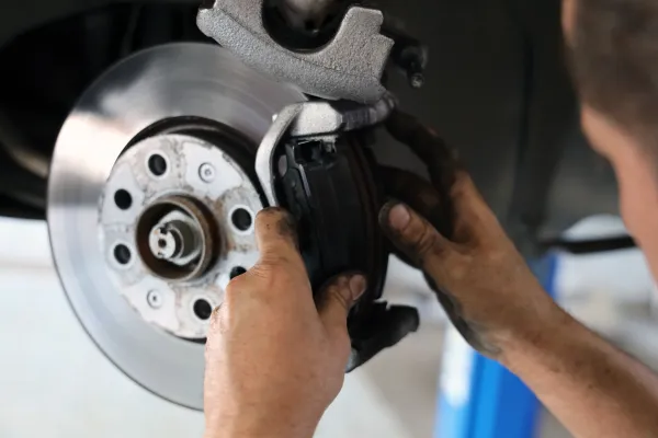 Acura of Brooklyn certified service center technician performing brake service