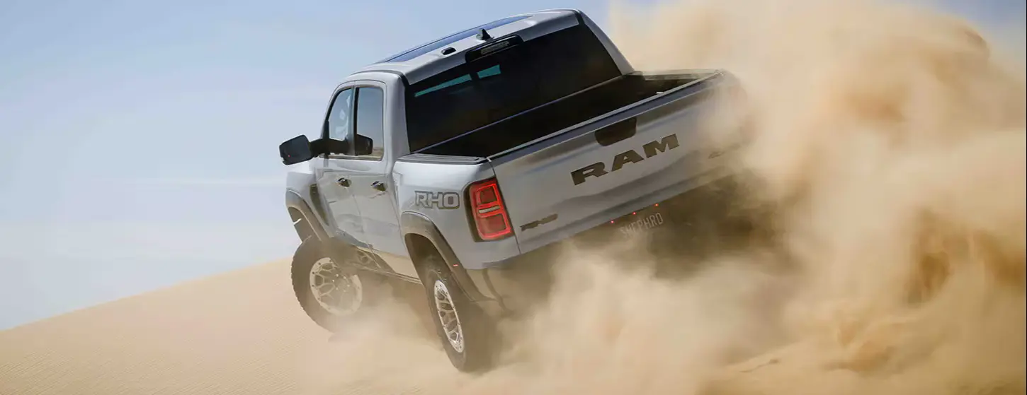ram rho driving and kicking up dust