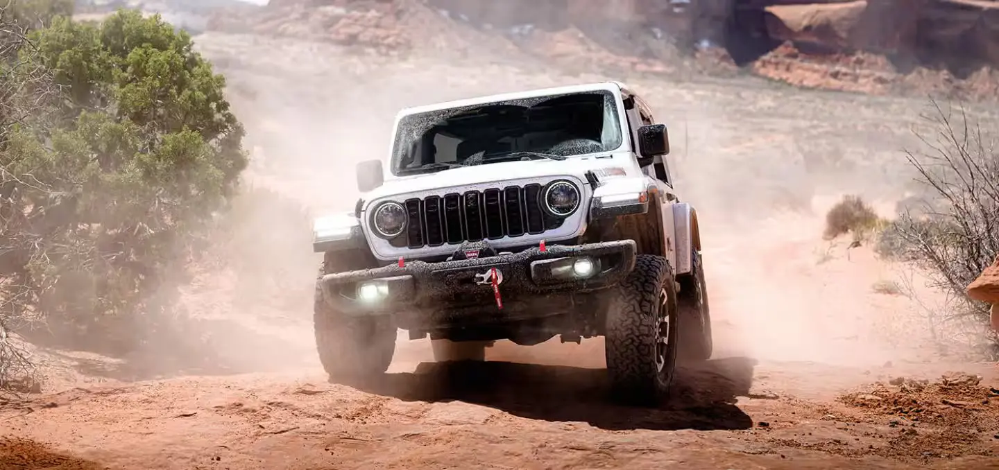 white jeep wrangler off-roading