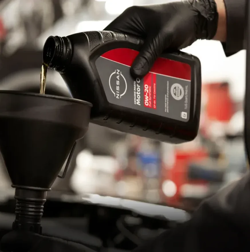 Nissan motor oil being poured during an oil change