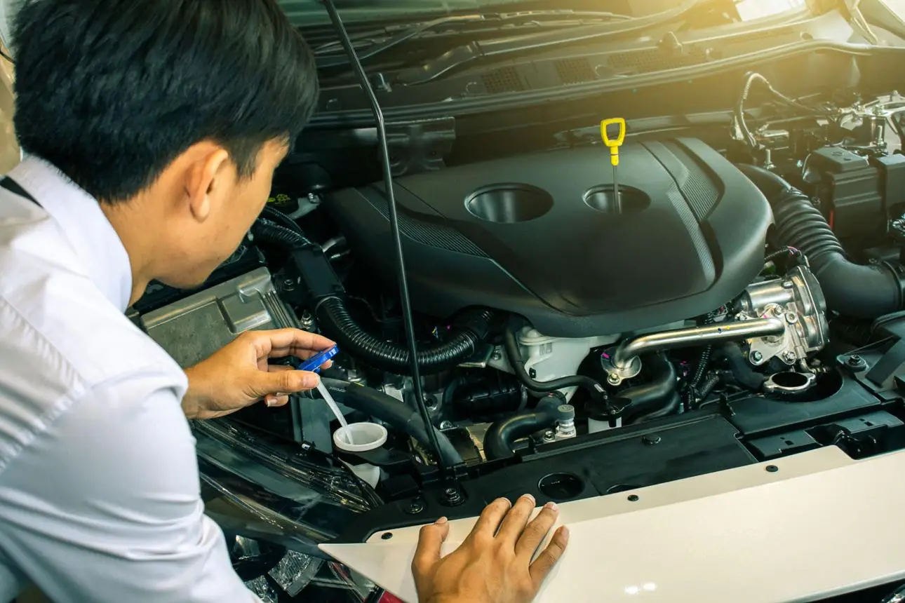 Technician servicing a vehicle under the AX Confidence Warranty