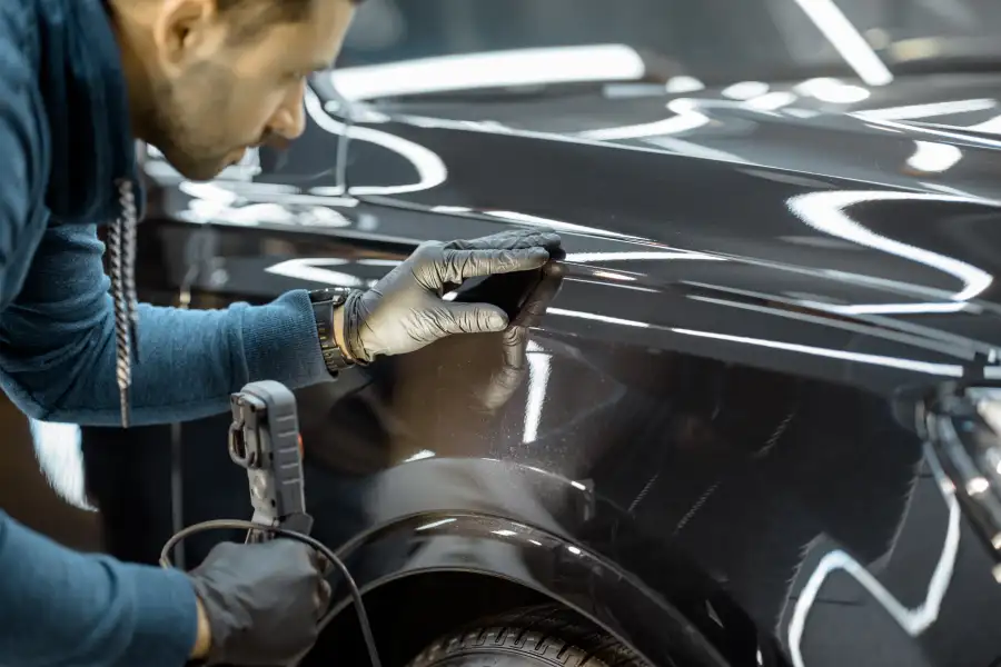 America's Xtreme Auto collision repair bays in Houston, TX with a vehicle undergoing frame restoration