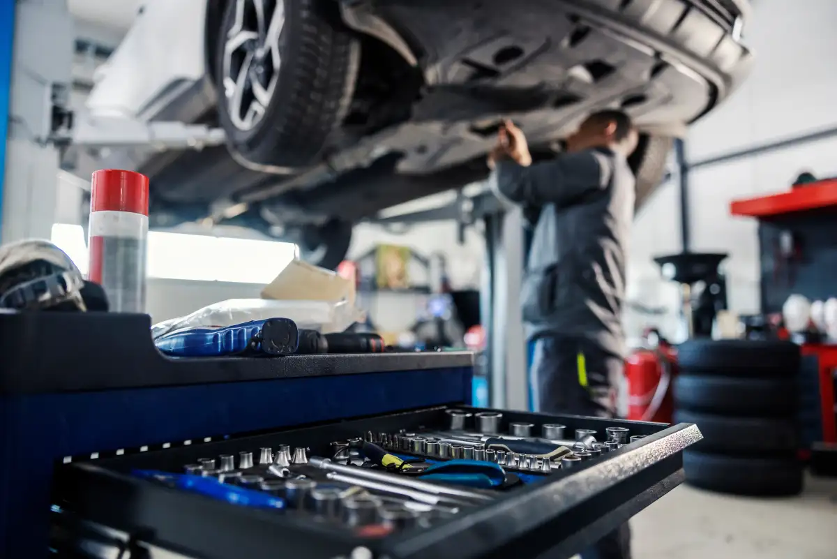 Vehicle on the lift during a maintenance service at Auto Sense North in Chichester, NH