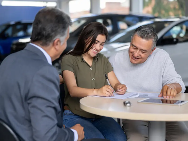 Sales associate reviewing financing paperwork with a customer