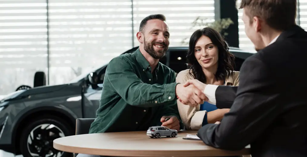 Customer completing a vehicle financing consultation at a dealership