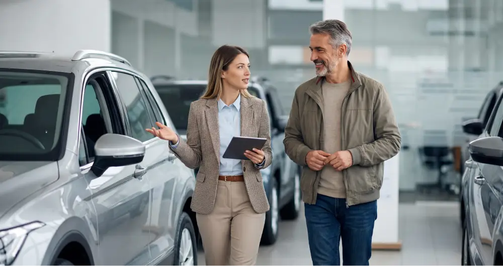 Autos of Chicago finance specialist helping a customer explore vehicle financing options in the showroom