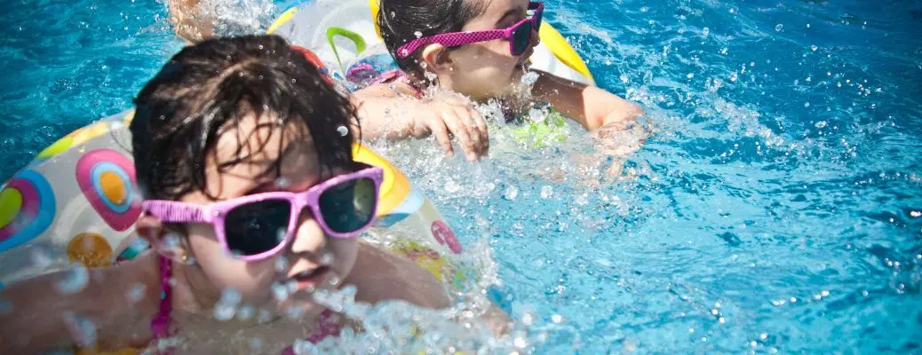 Kids playing in an indoor pool.