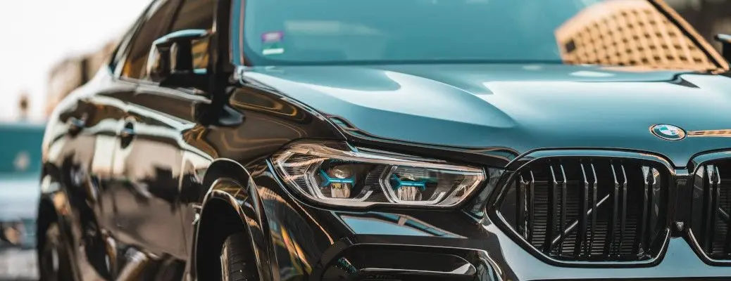 The headlights of a BMW sedan.