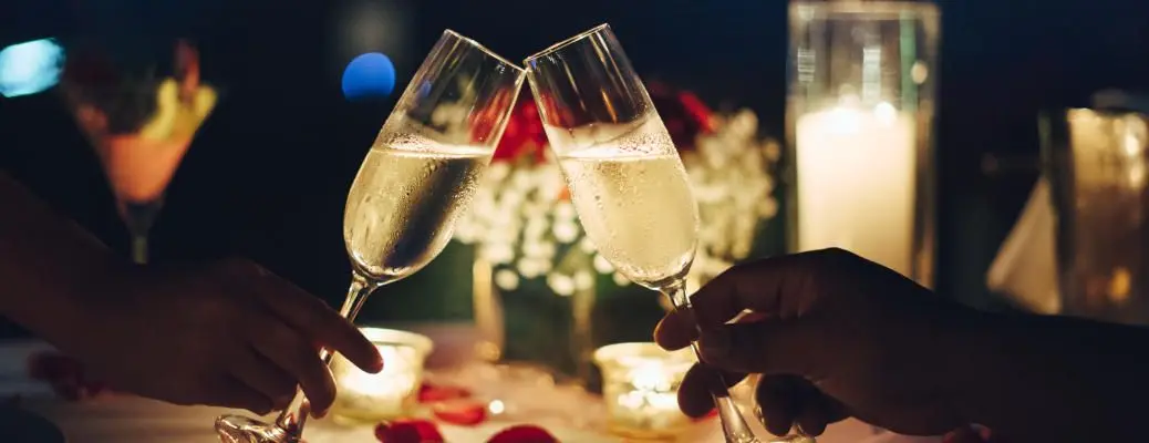 A couple toasting with champagne glasses.