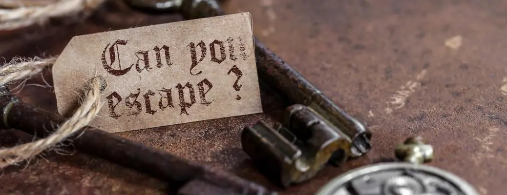 A key and a sign that says "Can you escape?" as part of an escape room experience near Dallas.