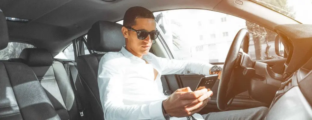 A man texting while driving in Texas, which is illegal.