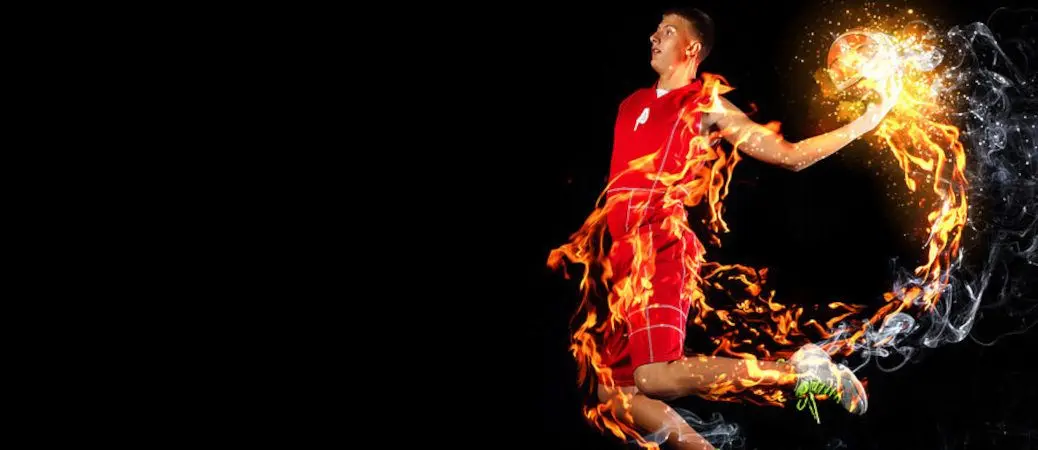A man about to dunk the basketball.