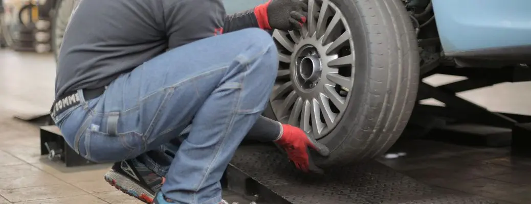 A man changing a tire.