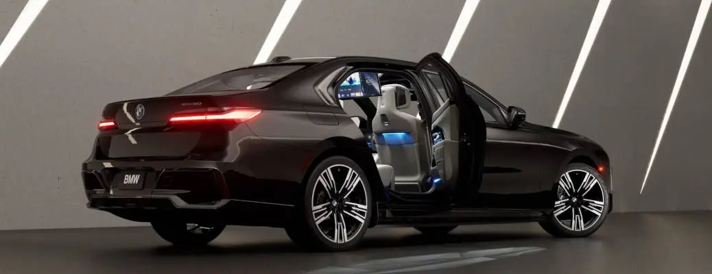 A tech-laden BMW 7-Series EV with its doors open.