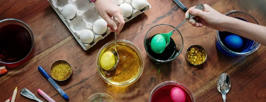 People coloring Easter eggs.