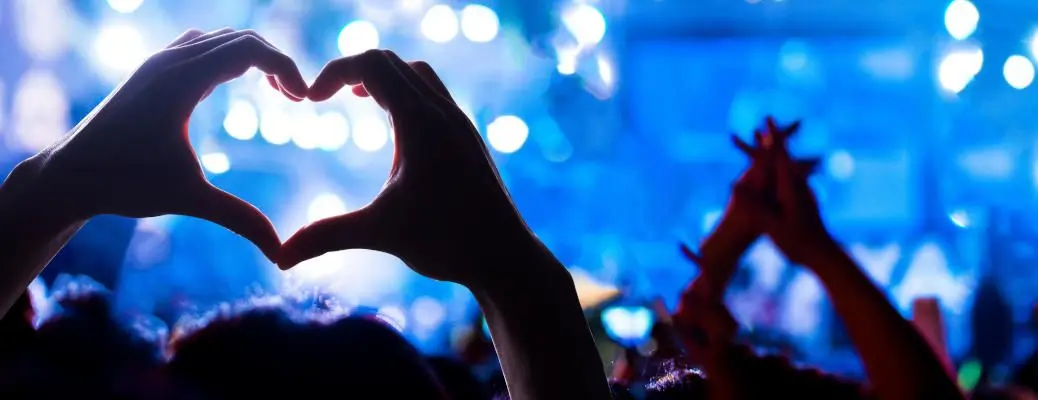 Heart hands at a concert.