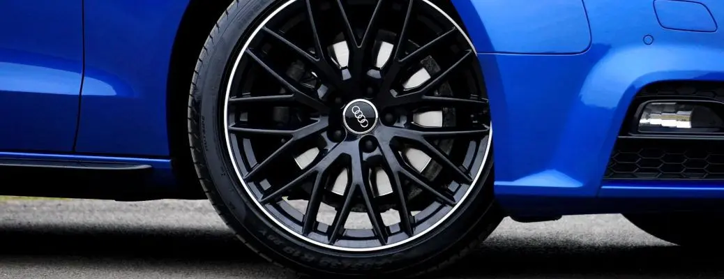 A close up of a new tire on an Audi.
