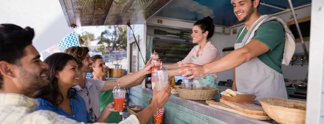 People getting food at a food truck