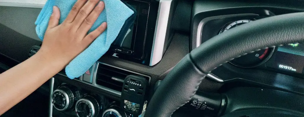 A person maintaining the interior of their car during the COVID lockdown.