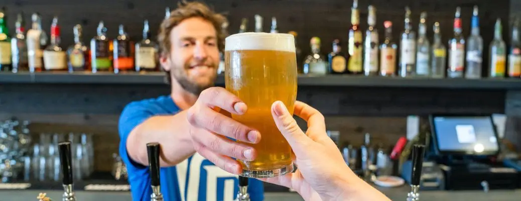 A man serving beer at a brewery near Dallas.
