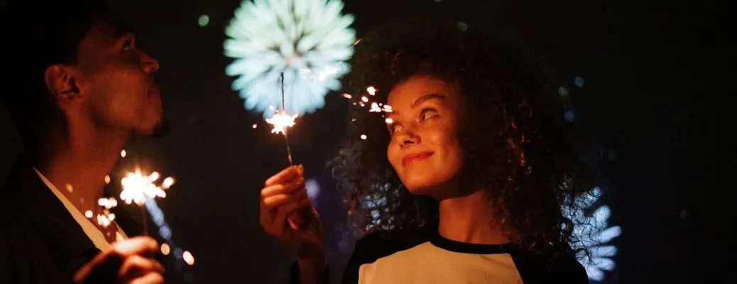 People outdoors with sparklers celebrating July 4th near Dallas.