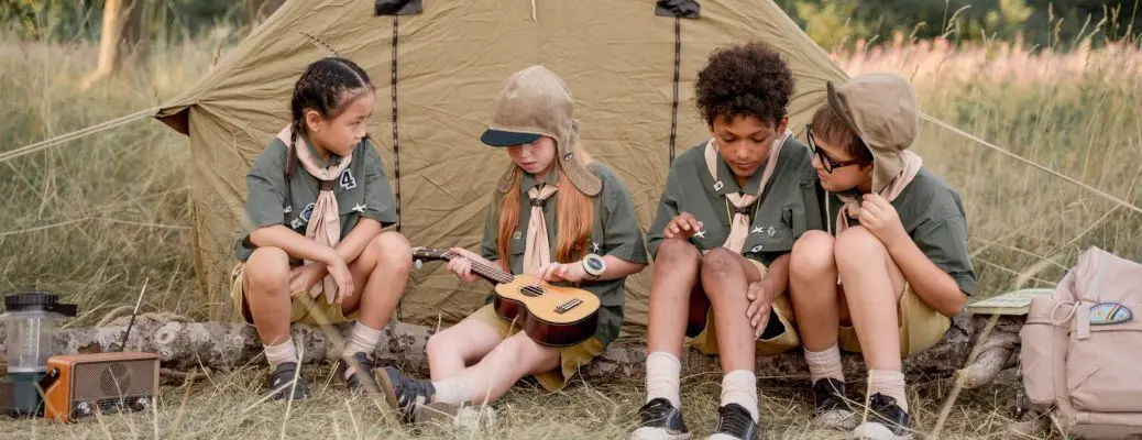 Kids camping near a tent.
