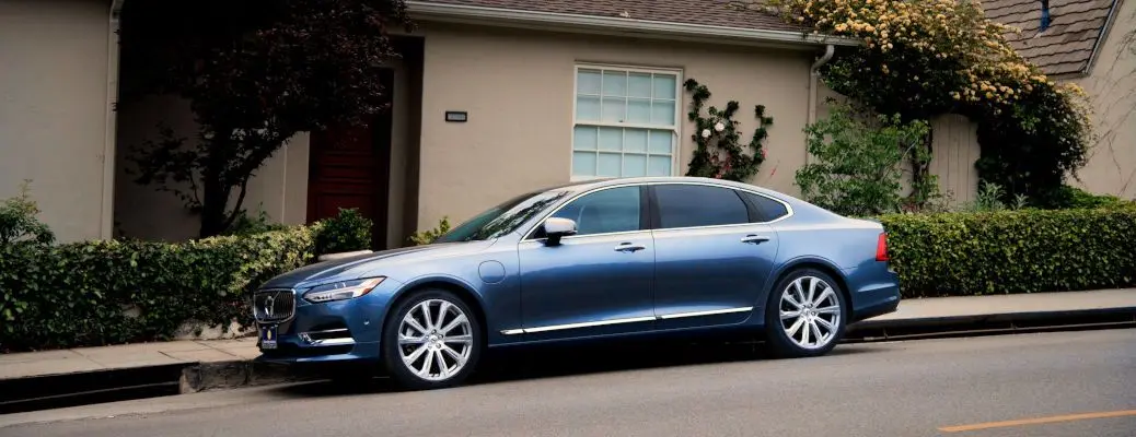 A BMW in front of a home via Affordable Nationwide Luxury Car Delivery.