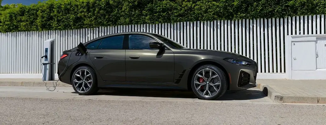 A 2024 BMW i4 EV at a charging station.