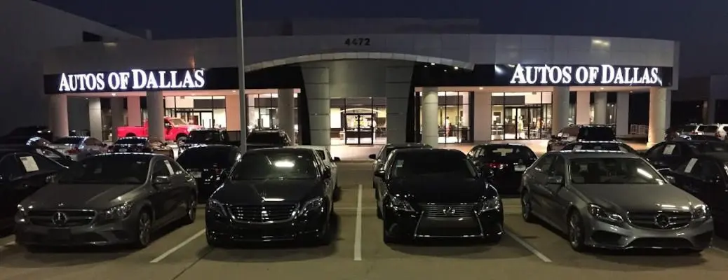 The exterior of the lot and showroom for Autos of Dallas, a luxury used car dealership near Dallas, TX.