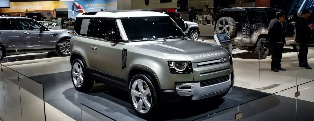 The exterior of the Land Rover Defender at an auto show.