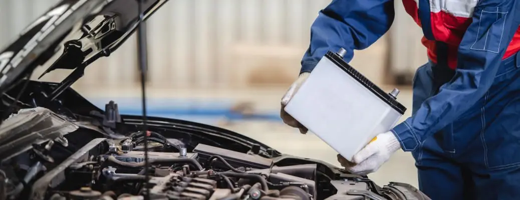 A man changing a car battery.
