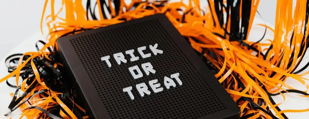 A festive Halloween sign that says trick or treat.