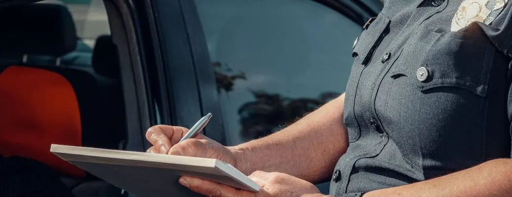 A person receiving a speeding ticket near Dallas.