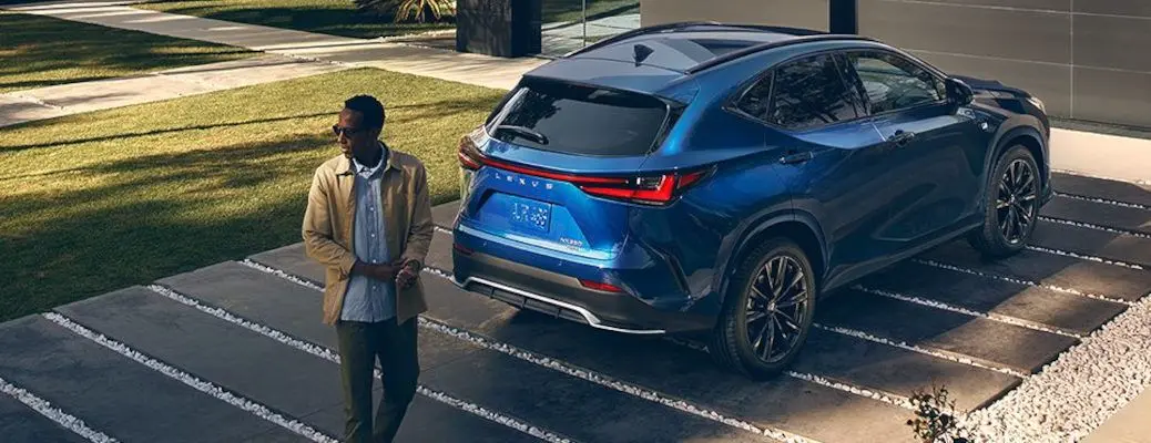 A blue Lexus in a driveway.