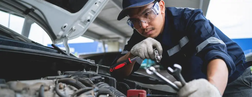 A mechanic working on an engine.