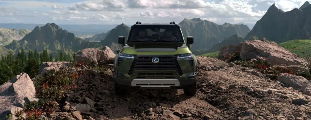 A front external view of the 2025 GX 550 on a rugged mountaintop.