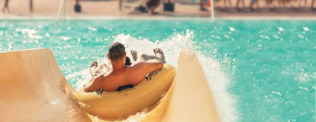 A man beating the heat near Dallas on a waterslide.