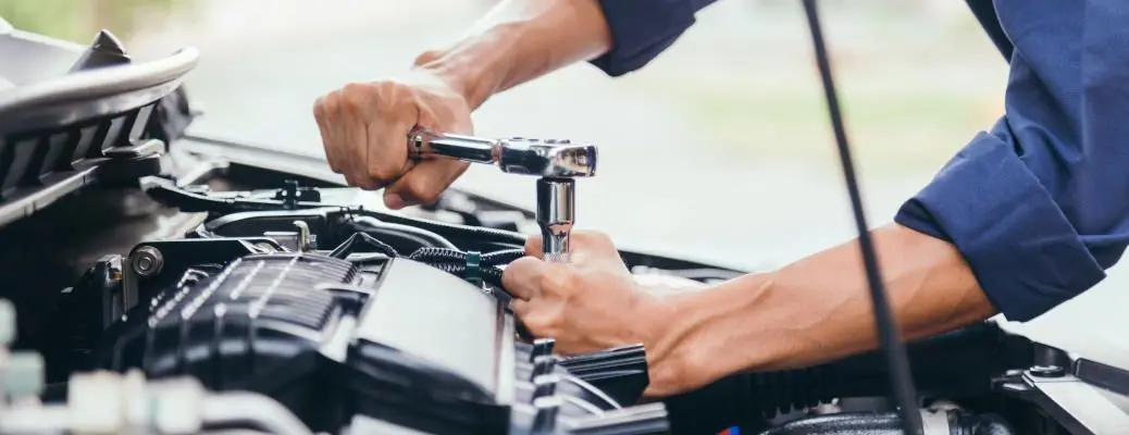 Automobile mechanic repairman hands repairing a car engine automotive workshop with a wrench, car service and maintenance,Repair service.