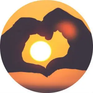 Two Hands Making a Heart with Sunset in the Background