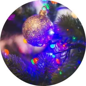 Close Up of Silver Christmas Ornament on a Tree with Lights