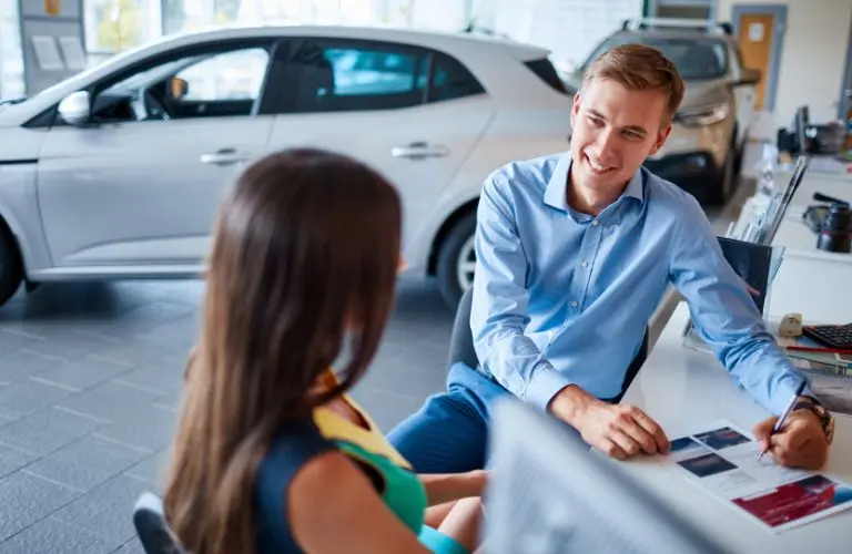 Customer and a salesman at a dealership