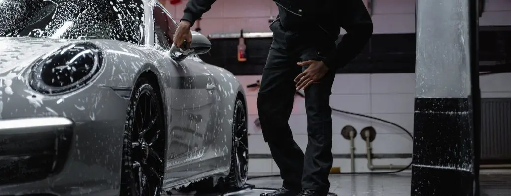 A man detailing a Porsche.