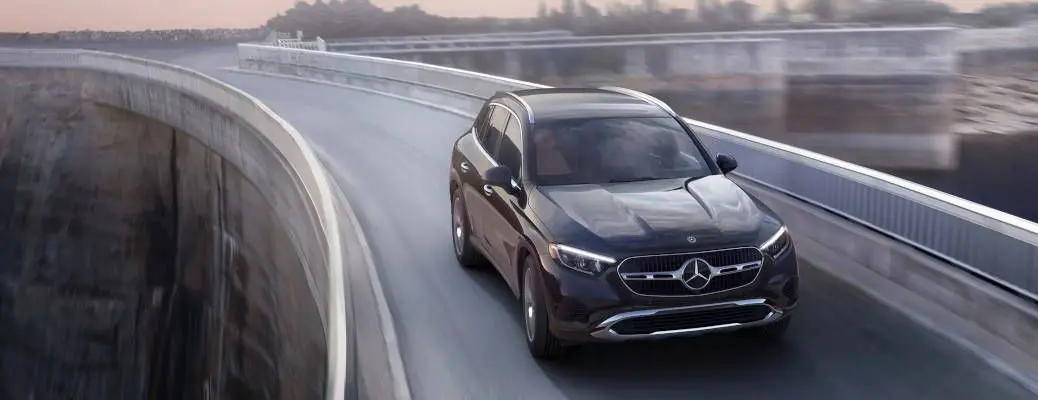 A front view of the Mercedes GLC driving on a rural highway.