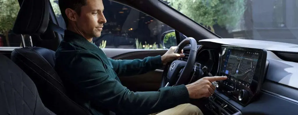A man using the high-tech infotainment system in the 2025 Lexus RX 350.