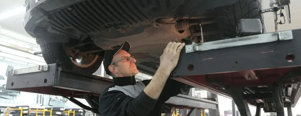 A man performing service on a car.