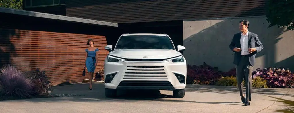 A couple near their luxury Lexus SUV near Dallas, Texas.