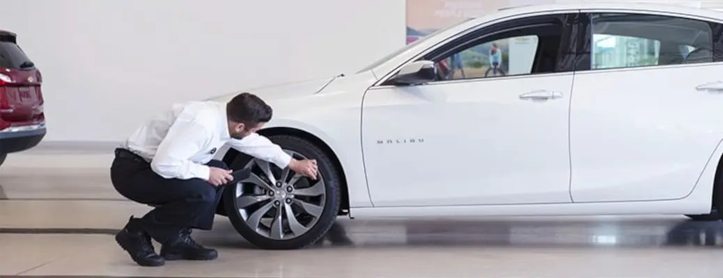 A man detailing the exterior of a car.