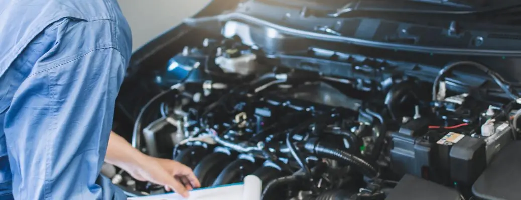 A man inspecting a motor.
