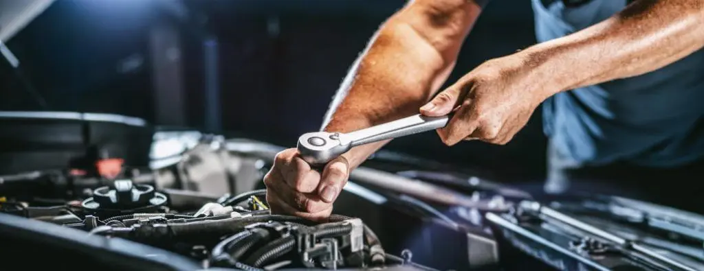 A man working on a car engine.