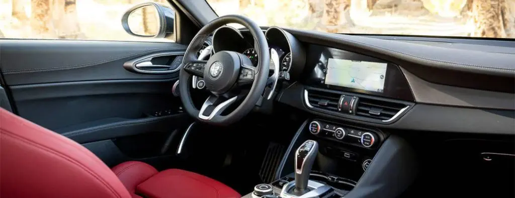 The cockpit of the 2022 Alfa Romeo Giulia, which can be found for sale near Dallas at Autos of Dallas.